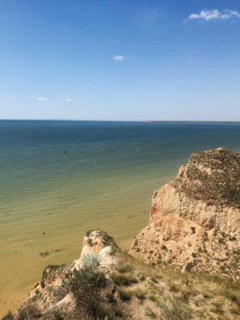 Breathtaking coastal landscape with towering cliffs alongside a calm, expansive sea under a clear blue sky. Grand Canyon Stanislav, Ukraine. Ideal for themes of nature, relaxation, and adventure.の写真素材