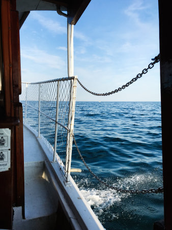 Experience a tranquil boat journey with clear blue skies and a vast open sea. Captured from the deck, the image evokes freedom and peacefulness. Nessebar, Bulgariaの写真素材