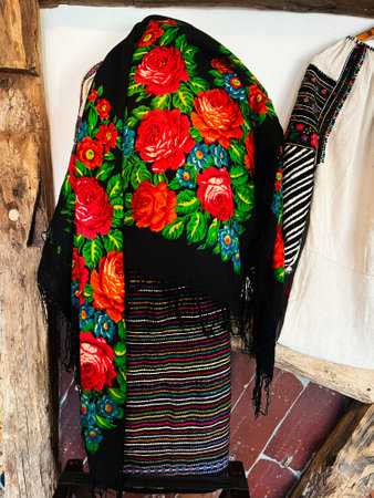 Vibrant floral patterns on traditional textiles create a colorful display, showcasing cultural...
