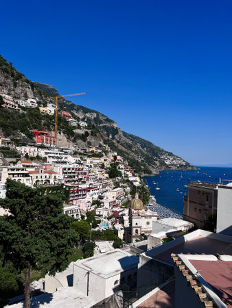 Captivating view of Positano on Italy's Amalfi Coast with colorful buildings, a picturesque sea, and lush greenery, offering a perfect travel and summer vacation destination.の写真素材