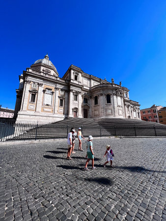 Family enjoys sunny day exploring historic architecture. Children play on cobblestone streets,...