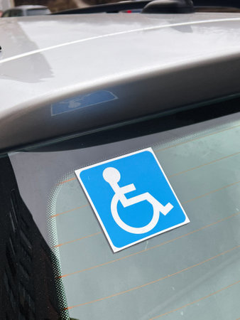 Accessible parking sign on a car, emphasizing inclusivity and facilities for disabled users.の写真素材