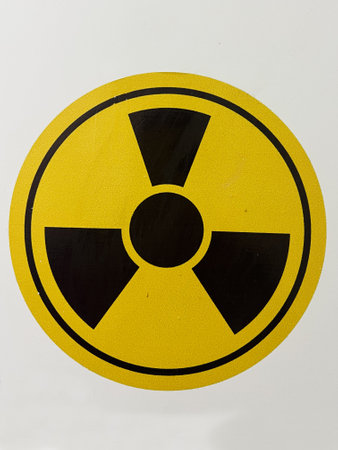 Yellow and black radiation hazard symbol indicating the presence of radioactive materials or danger.