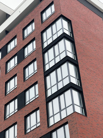 A stylish brick building with modern windows, showcasing an urban architectural style.の写真素材