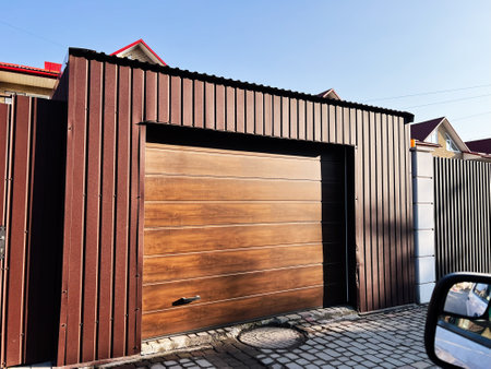 Stylish sectional brown garage door with modern architecture details and clean design.