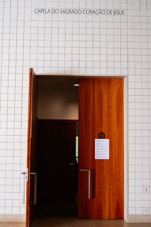Fatima, Portugal - March 26, 2025: Interior view of the chapel entrance featuring wooden doors and tiled walls.の写真素材