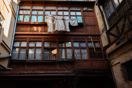 Rustic charm of Lviv buildings with laundry drying under warm daylightの写真素材