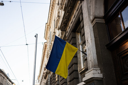 Blue and yellow Ukrainian national flag displayed on a historic building in Lviv