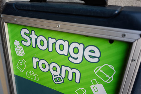 Green sign with illustrations indicating a storage room for luggage and bags.の写真素材