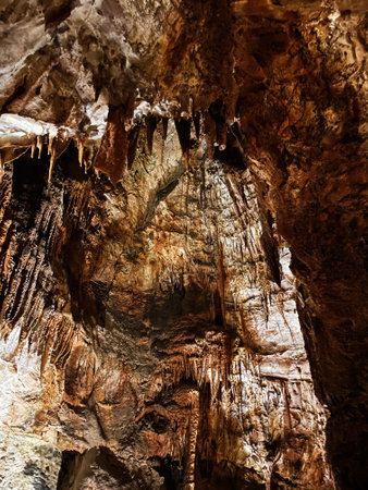 Beautiful stalactites and stalagmites create a surreal atmosphere inside this rock cave in Mira de Aire, Portugal.の写真素材