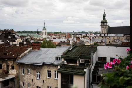 A captivating view of city rooftops with historic buildings and distant church spires in Lviv,...