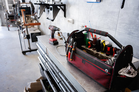 A detailed view of a toolbox with various tools in a professional workshop.
