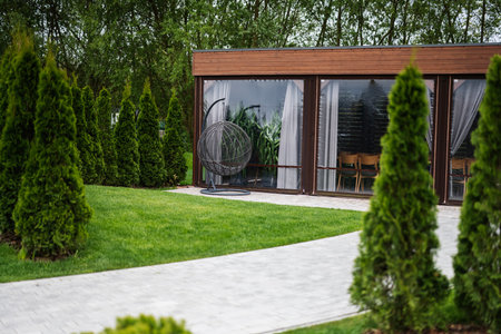 Contemporary patio surrounded by lush trees and plants for relaxation and comfortの写真素材