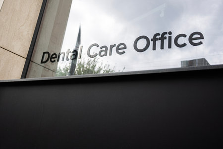 Modern dental care office with exterior reflective glass windows and visible signageの写真素材