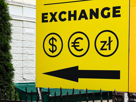 Yellow exchange sign with currency symbols and arrow indicating direction.の写真素材