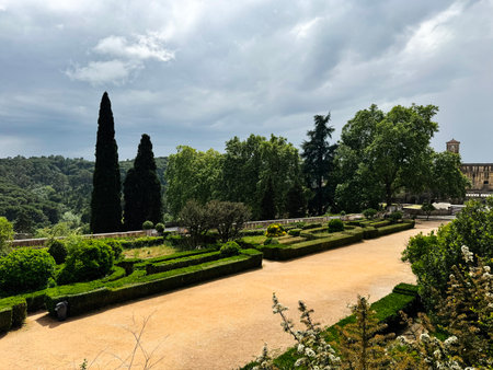 Manicured gardens with cypress trees and lush greenery near Tomar Castle in Portugalの写真素材