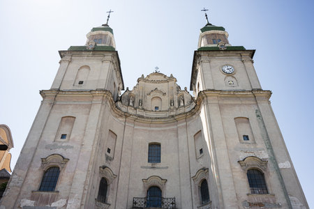 European historic cathedral church of Saint Anthony and Bernardine Monastery in Zbarazh with detailed architecture and twin towers viewed from belowの写真素材