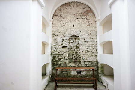 Interior view of a historical columbarium with stone and white painted walls.の写真素材
