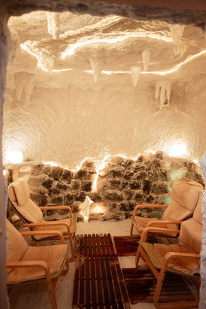 Four armchairs inside a salt cave illuminated by warm, ambient lights.の写真素材