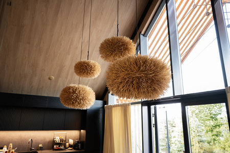 Contemporary living space featuring distinctive lighting fixtures with natural and warm accentsの写真素材