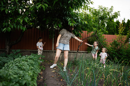 A happy family bonding outdoors in a vibrant garden with trees and plants.