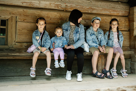 A family enjoying a relaxing moment together on a rustic wooden bench.