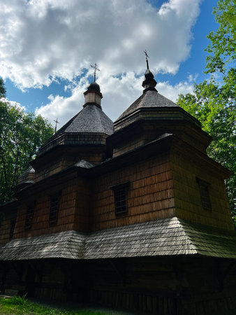 A wooden ukrainian church in a natural environment with a serene and historical atmosphereの写真素材