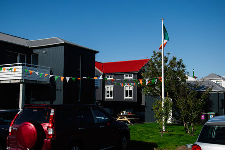 A festive Irish community scene with flags and decorations in vibrant Iceland setting