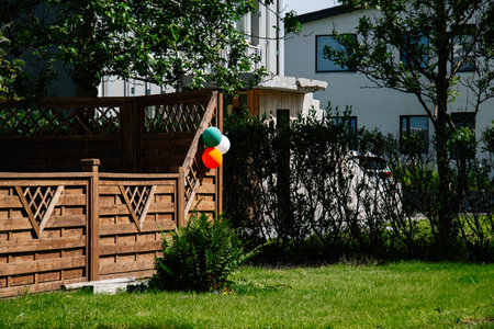 Wooden garden fence with balloons in Akranes, Iceland, creating a festive feelingの写真素材