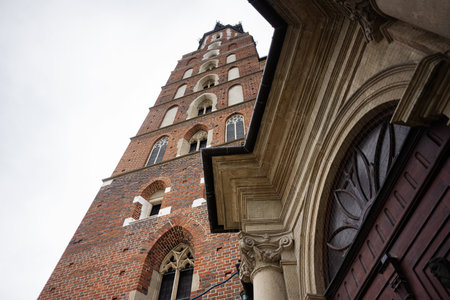 Gothic-style St. Mary's Basilica church building in Krakow Poland viewed from below featuring intricate detailsの写真素材