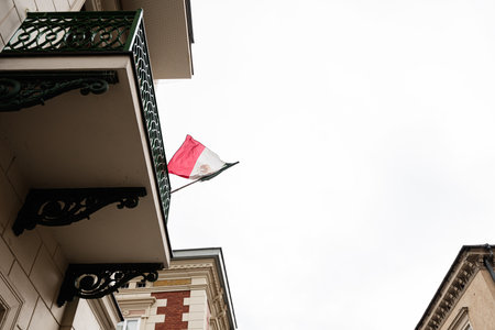 Mexican flag displayed on a balcony showcasing international connection.
