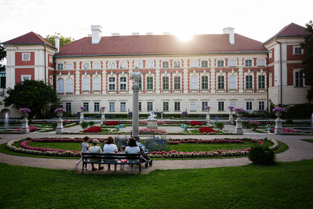 A scenic view of Lancut's palace gardens with visitors enjoying the serene setting.の写真素材