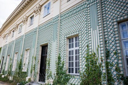 Elegant building facade in Lancut, Poland, adorned with decorative trellis and ivy.の写真素材