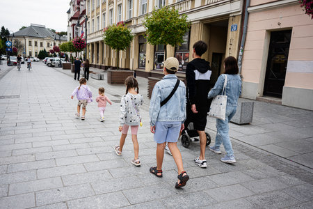 People strolling on a pedestrian street in Rzeszow, Poland on a cloudy day