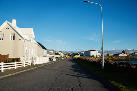 Peaceful coastal town street in Iceland with sunny weather and clear skiesの写真素材