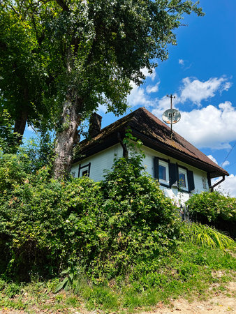 Bright day at a countryside home surrounded by greenery and natureの写真素材