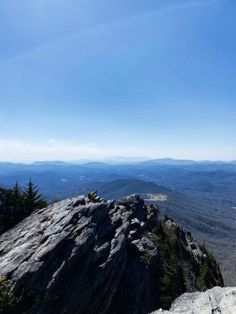 Rugged Grandfather Mountain rocky peak offers a dramatic panorama across valleys and forested hills.の写真素材