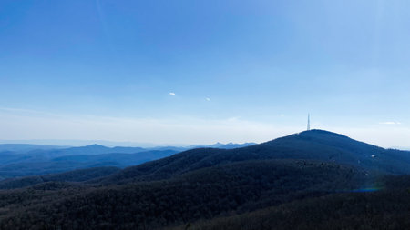 Quiet mountain landscape in North Carolina under a clear blue sky with a hilltop radio tower.の写真素材
