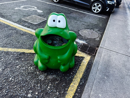 Dublin, Ireland - October 21, 2025: Colorful frog trash can in a parking space adds whimsy to urban Ireland.のeditorial素材