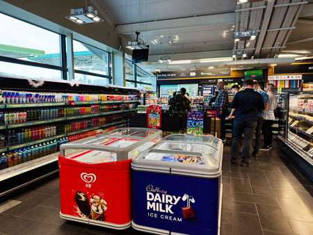 Dublin, Ireland - October 21, 2025: Busy store scene in Ireland with frozen desserts and beverages as shoppers browse and shop.のeditorial素材