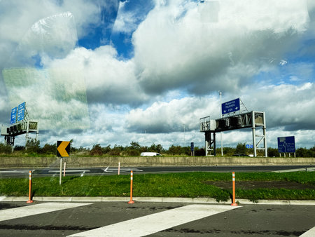 Dublin, Ireland - October 21, 2025: Ireland highway scene featuring road signs, traffic cones, and a dramatic cloudy sky.のeditorial素材