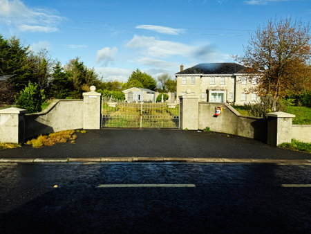 Longford, Ireland - October 21, 2025: A quiet Irish country estate scene featuring a gated driveway, stately home, and landscaped grounds.のeditorial素材