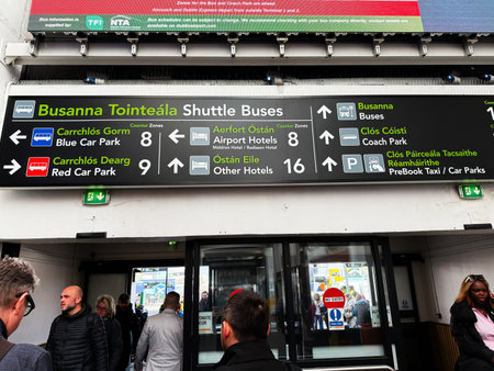 Dublin, Ireland - October 21, 2025: Crowded terminal entrance with a large signboard showing bus...
