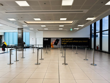 Dublin, Ireland - October 21, 2025: Spacious Dublin airport terminal featuring an Uber advertisement...
