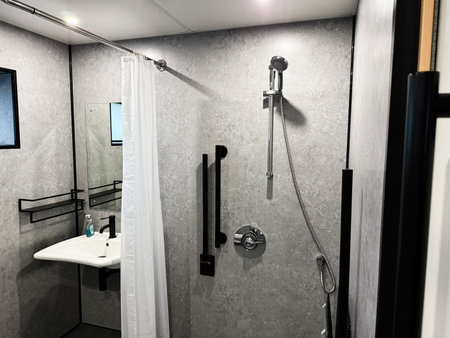 Knock, Ireland - October 22, 2025: Compact modern shower room in Knock, Ireland featuring a handheld shower, minimalist fixtures, and a clean design.のeditorial素材
