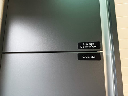 Knock, Ireland - October 22, 2025: Industrial metal cabinet with fuse box and wardrobe labels in a neat storage area in Knock Ireland.のeditorial素材