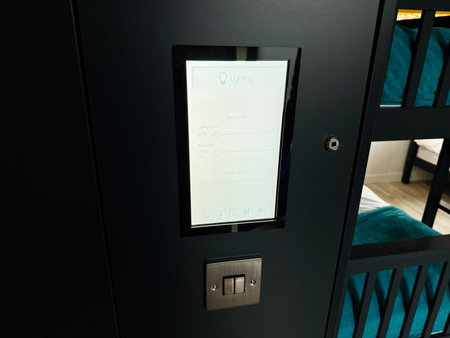 Knock, Ireland - October 22, 2025: Contemporary lighting panel installed on a dark wall beside a bunk bed in Knock Ireland.のeditorial素材
