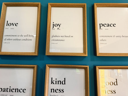 Knock, Ireland - October 22, 2025: A grid of wooden framed word art on a teal wall highlighting positive virtues.のeditorial素材