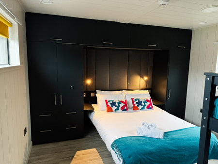 Knock, Ireland - October 22, 2025: Cozy, modern bedroom with built in wardrobes, decorative pillows, and teal throw in Knock Ireland.のeditorial素材