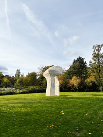London, UK - October 05, 2025: Outdoor abstract sculpture The Arch by Henry Moore in a London park, surrounded by trees and a well kept lawn.のeditorial素材
